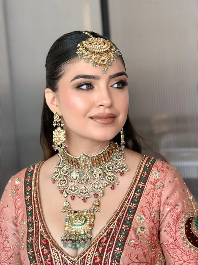 Red lehenga bridal look with sculpted glam